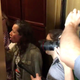 A protester steps into the elevator doorway to confront Flake.